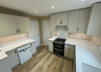 Painted timber shaker kitchen in 'shell' with quartz worktops and splashback