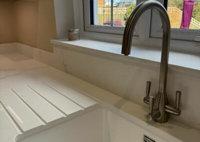 Quartz worktop with composite sink in white, and chrome 3 way tap